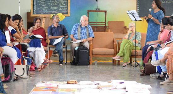 A workshop by Christof Wiechert in progress at Sloka - The Hyderabad Waldorf School, as a group of teachers interact in a circle.