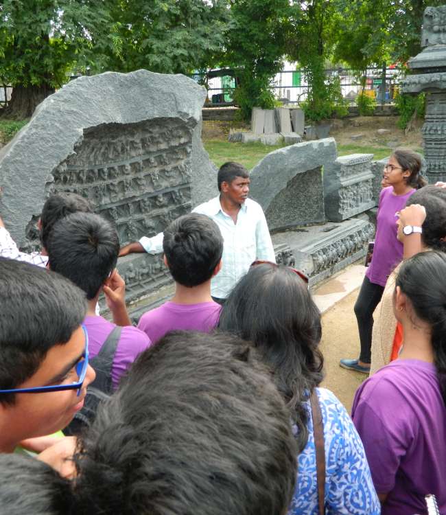 Students from Sloka - The Hyderabad Waldorf School looking at stone sculptures during a field trip.
