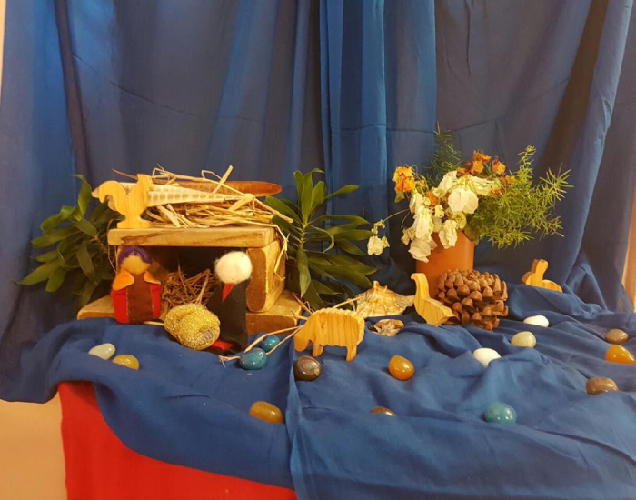 A nativity installation by students of Sloka exhibited on a blue cloth backdrop