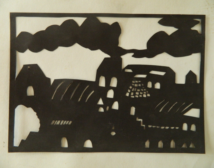 A paper collage artwork made by a student of Sloka with black paper cutouts on a white background.